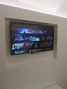 a flat screen tv hanging on a wall at Casetta Verga Loft in Catania
