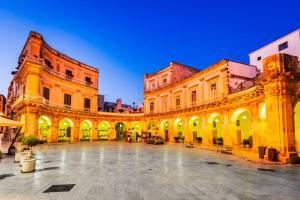 a large building with a courtyard in front of it at Corsomessapia121 in Martina Franca