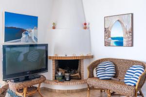 a living room with two chairs and a television at Porto sea view house - 15min from Athens airport - AC - WIFI - PARKING in Porto Rafti