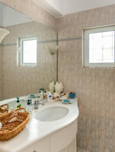 a bathroom with a sink and a mirror at Porto sea view house - 15min from Athens airport - AC - WIFI - PARKING in Porto Rafti