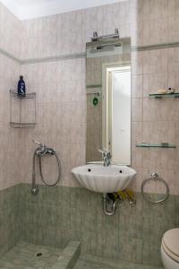 a bathroom with a sink and a toilet and a mirror at Porto sea view house - 15min from Athens airport - AC - WIFI - PARKING in Porto Rafti +29 photos