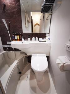 a bathroom with a white toilet and a sink at HOTEL MOND Omiya - Vacation STAY 85327v in Saitama