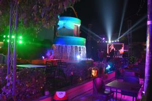 a party with a fountain and tables and lights at Hotel Natraj in Bilāspur