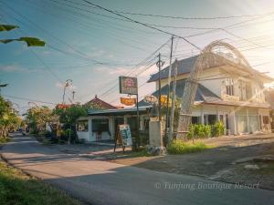 a street with a building on the side of a road at The Tunjung Boutique Resort in Dalung