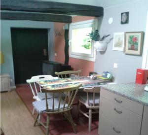 a kitchen with a table and chairs and a counter at Vivans Bed and Self catering in Kristianstad