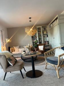 a living room with furniture and a chandelier at Hotel La Licorne in Carnac