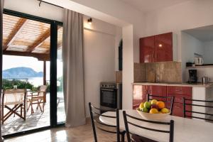 a kitchen with a table with a bowl of fruit at Villa Flisvos in Marathias