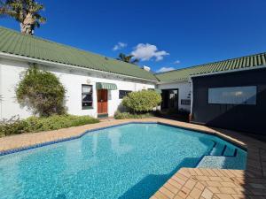 a swimming pool in front of a house at The Hide on Tindale in East London