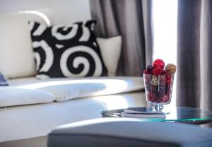 a glass vase with berries and nuts on a table at Apartments Villa Capitano in Mlini