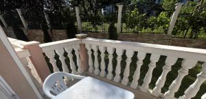 a white chair sitting on a white railing at Cozy Elegant Room in Perla Del Mar complex in Lozenets