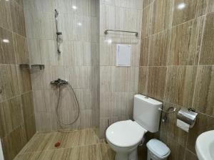 a bathroom with a shower and a toilet and a sink at Cozy Elegant Room in Perla Del Mar complex in Lozenets