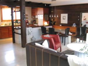 a kitchen and living room with a couch and a table at Casa Almis, Grindelwald in Grindelwald