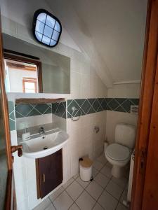LouvarasにあるStone built country house in Louvaras Villageのバスルーム(洗面台、トイレ付)、窓が備わります。