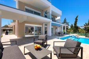 a villa with a swimming pool and a patio at Viviane Paulos Villa in Gennadi