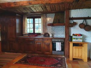 a kitchen with wooden cabinets and a stove at Chalet Charme Ovronnaz in Ovronnaz