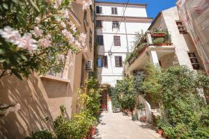 an alley with flowers and plants in a building at City Premium Rooms Old town in Zadar