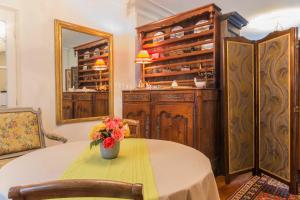 a room with a table with a vase of flowers on it at Chambre d'hôtes Le Petit Tertre in Dijon