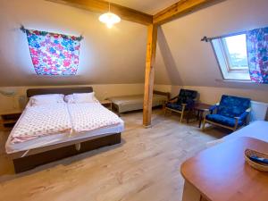 a bedroom with a bed and a table and chairs at István Vendégház in Eger