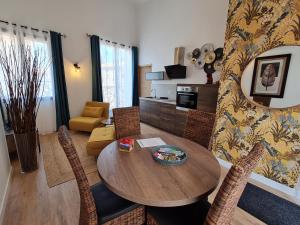 salon z drewnianym stołem i krzesłami w obiekcie Gite cosy dans une demeure de charme - Laura w mieście Thuir +16 zdjęć