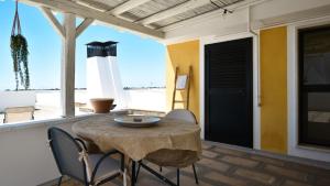 a patio with a table and chairs and a lighthouse at Les Maisons La Mansardina by Rentbeat in Sannicola