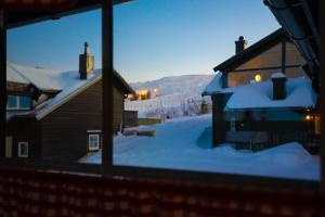 a view from a window of a house in the snow at Fagertoppen 12B in Trysil