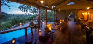 a room with a view of a swimming pool in a tent at Serengeti Migration Camp in Serengeti National Park +34 photos