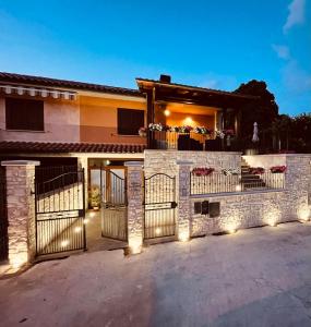 a house with a gate with lights on it at Affittacamere Residenza Montedoro in Norcia