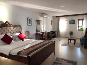 a bedroom with a large bed and a living room at Citadela Old Town - Gelateria in Ulcinj