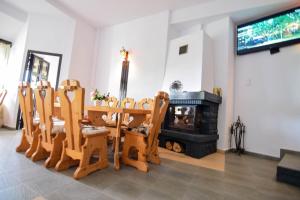 a living room with chairs and a fireplace at Pensiunea Ursuleț Bran in Bran