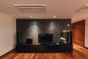 a living room with a flat screen tv on a table at InterContinental Residences Saigon, an IHG Hotel in Ho Chi Minh City