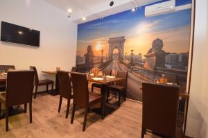 a dining room with a painting of a bridge at Fig Tree House in Budapest