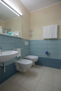 a bathroom with a sink and a toilet at Hotel Fabricia in Portoferraio