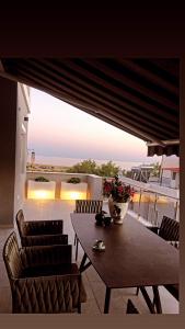 a table and chairs on a balcony with a view of the ocean at Sea View Residence by MD in Alexandroupoli