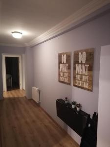 a living room with two posters on the wall at House KA Naz in Çanakkale