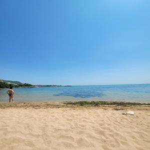 a person standing on a beach near the water at Ecopark Tuzlata Екопарк Тузлата in Balchik