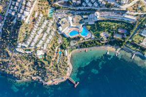 an aerial view of a resort next to the water at Yasmin Bodrum Resort in Gumusluk