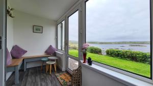 a room with a window with a view of the water at Tigh Beag Na Mara in Roag