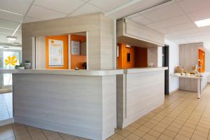 a lobby of a hospital with a reception counter at Premiere Classe Nantes Ouest - St Herblain in Saint-Herblain