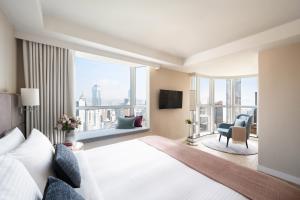 a hotel room with a bed and a large window at Two MacDonnell Road in Hong Kong