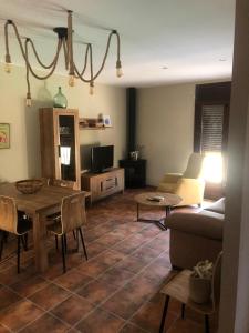 a living room with a table and a couch at Casa Rural El Corral del Tío Santiago in Mazaleón +10 photos