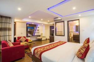 a bedroom with a bed and a living room at Avataar Kathmandu Hotel in Kathmandu