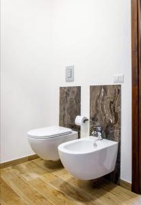 a bathroom with a white toilet and a sink at B&B Da Antonella in Troina