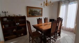 a dining room with a wooden table and chairs at Pavillon de Diane, Le Malesherbois 