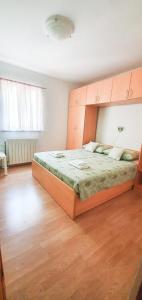 a bedroom with a large bed in a room at Apartments Sara in Podstrana