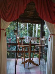 a table and two chairs under a tent at Casa Cravo & Canela in São Pedro da Serra