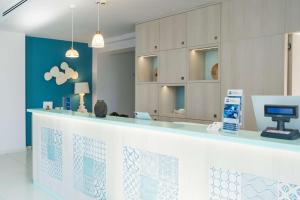 a hospital reception counter with a computer on it at Best Western Hotel Blumarea in Castelsardo