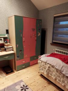 a bedroom with a bed and a desk and cabinets at Goradil Beach in Baku