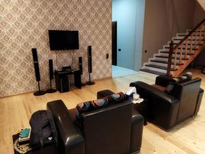 a living room with two chairs and a television at Goradil Beach in Baku