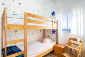 a bunk bed in a room with a chair at Casa Jazmín in Santa Cruz de Tenerife