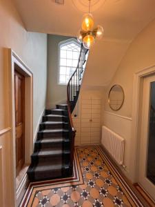 a hallway with a spiral staircase in a house at The Glen House in Kinsale